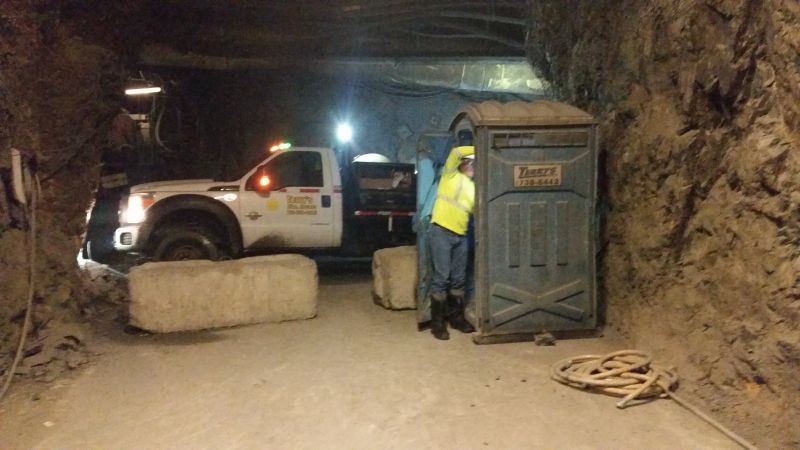 Domingo Garcia, the underground service technician, cleans out a restroom from PolyPortables, a division of Satellite, deep in a gold mine. The truck is a Ford F-550 with a 350-gallon aluminum waste tank and Masport pump. (Photo courtesy of Joe Payne)